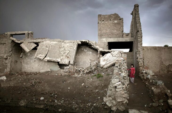 What justice for the victims in Afghanistan? An Afghan girl stands at the entrance of her house near a destroyed compound, in the old part of Kabul, on April 10, 2010.