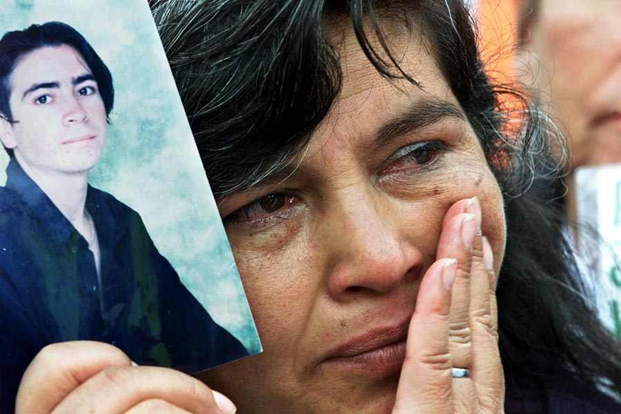 In Colombia, a mother holding a photo of her son kidnapped by a rebel group, Bogota, May 2001.