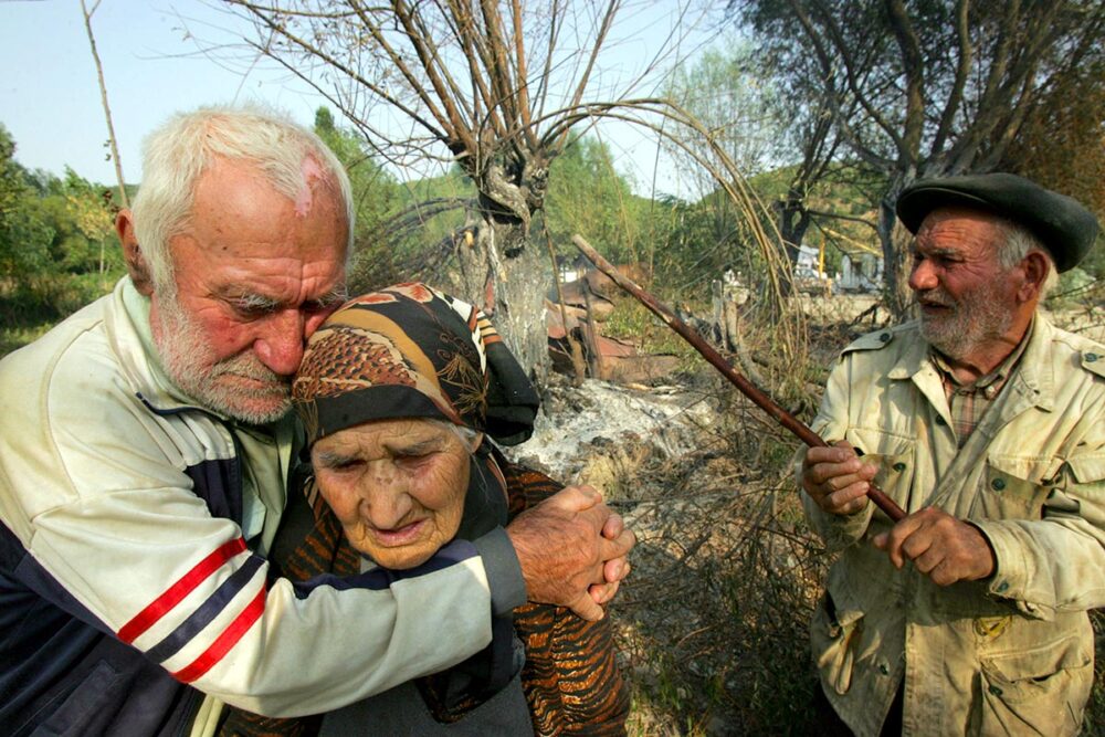 Georgia's 2008 war against Russia: who will pay compensation for the victims? Photo: Elderly civilian victims near their burnt-down home following the Russian invasion.