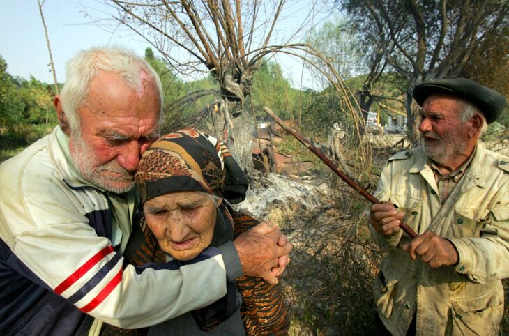 Georgia's 2008 war against Russia: who will pay compensation for the victims? Photo: Elderly civilian victims near their burnt-down home following the Russian invasion.