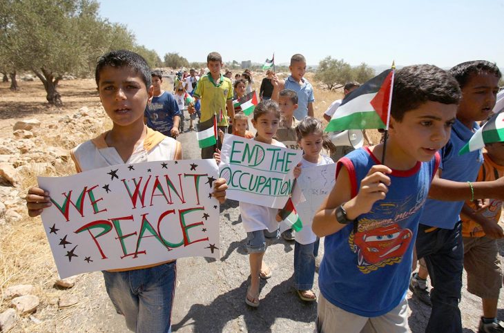 Demonstration of Palestinian children holding up signs that read 