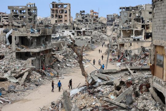 Israel & Palestine - ICC arrest warrants against Netanyahu and Gallant. Photo: Palestinians walk on a dirt road lined with rubble from destroyed buildings in the Shujaiya neighbourhood of Gaza City.