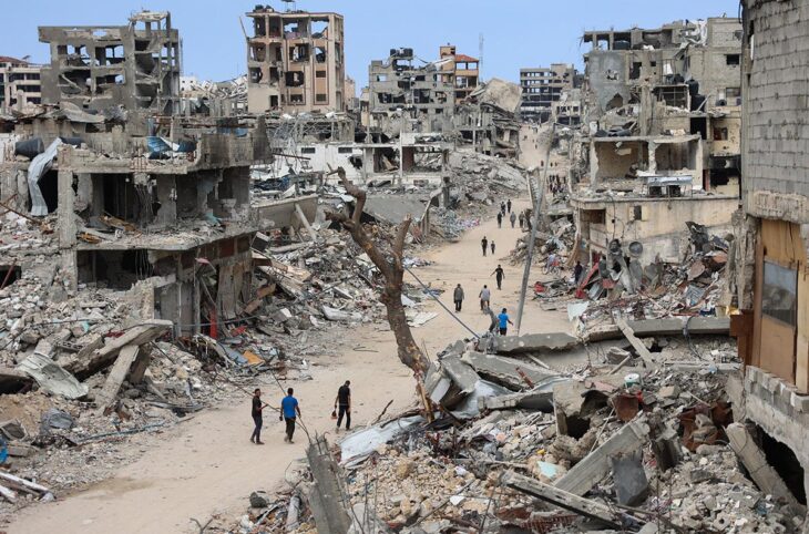 Israel & Palestine - ICC arrest warrants against Netanyahu and Gallant. Photo: Palestinians walk on a dirt road lined with rubble from destroyed buildings in the Shujaiya neighbourhood of Gaza City.