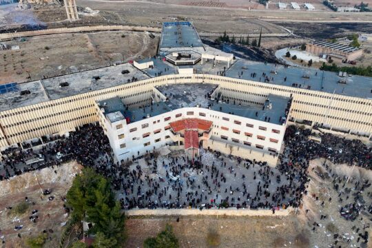 ICC & Syria - An aerial photo shows people gathering around Saydnaya prison in Syria.