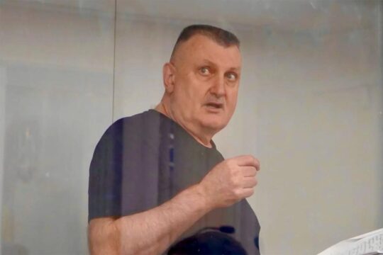 Trial of Mykola Fedorian in Ukraine for crimes of treason committed in Russian-occupied Crimea. Photo: Fedorian at his trial in Kyiv, behind the glass of the dock.