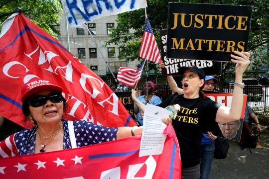 Supporters and opponents of Donald Trump scuffle as they wait for a verdict in Trump's hush money criminal trial outside Manhattan Criminal Court on May 29, 2024 in New York City.