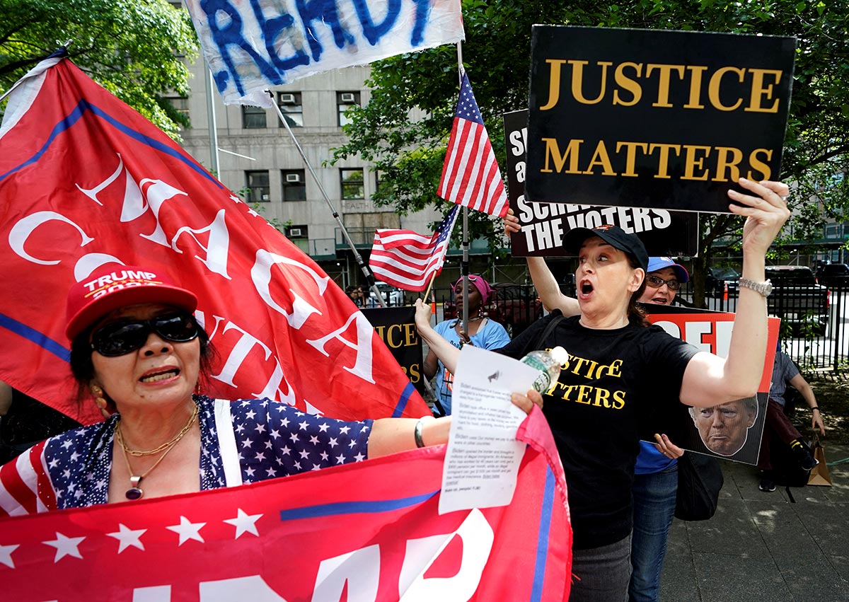 Supporters and opponents of Donald Trump scuffle as they wait for a verdict in Trump's hush money criminal trial outside Manhattan Criminal Court on May 29, 2024 in New York City.